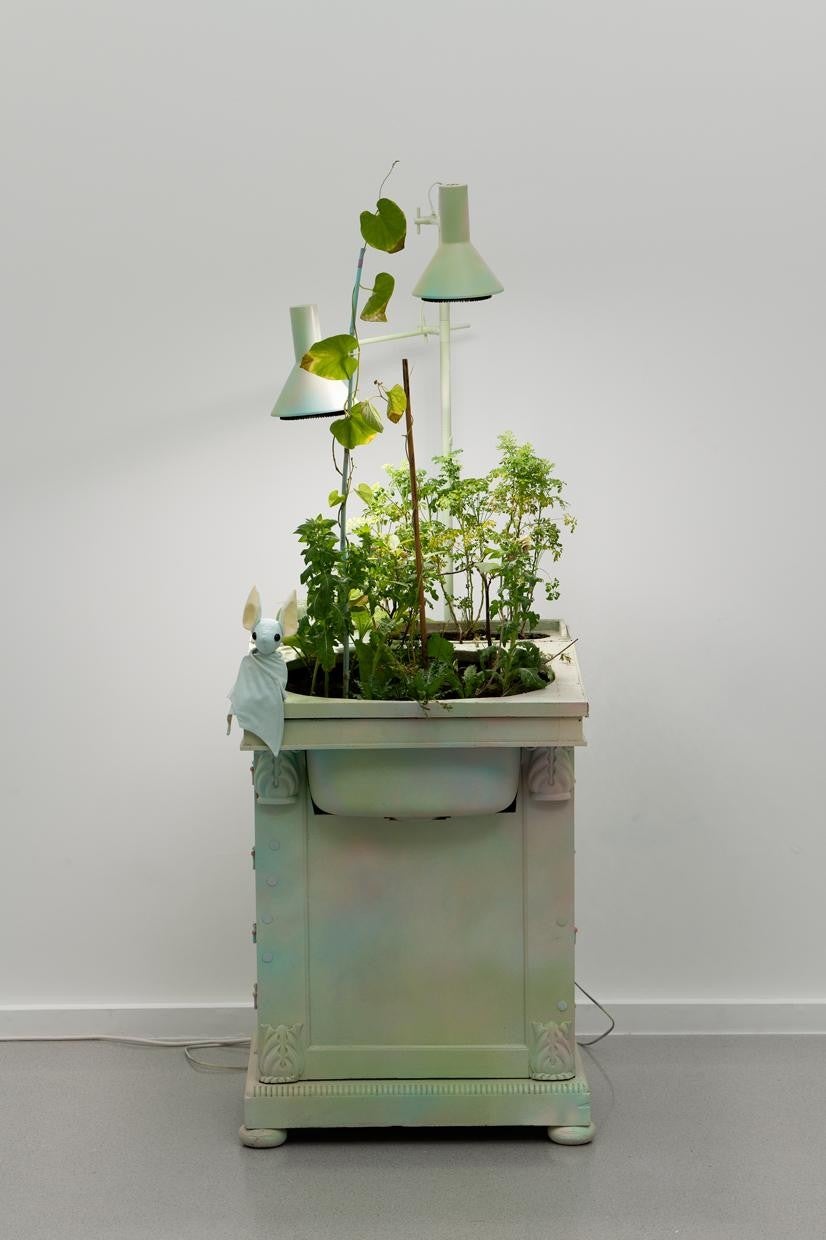 Benoît Piéron, <i>L'Écritoire</i> (Writing Table), 2023, painted furniture, glitter, plush, deadly plants, horticultural light, sewing pattern by BeeZee art. Photo: Galerie Sultana. Courtesy Benoît Piéron and Galerie Sultana
